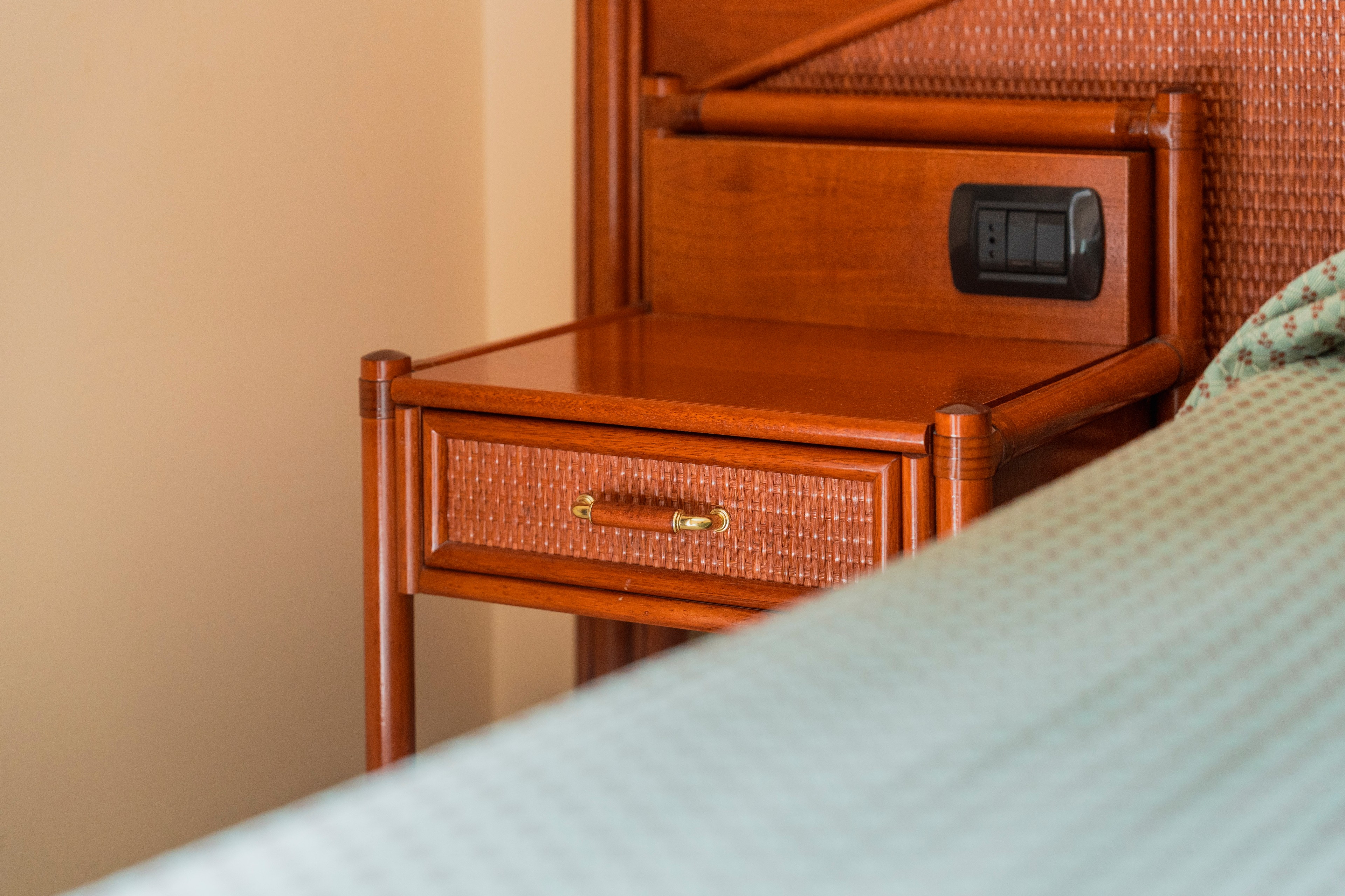 Comodino in legno accanto al letto